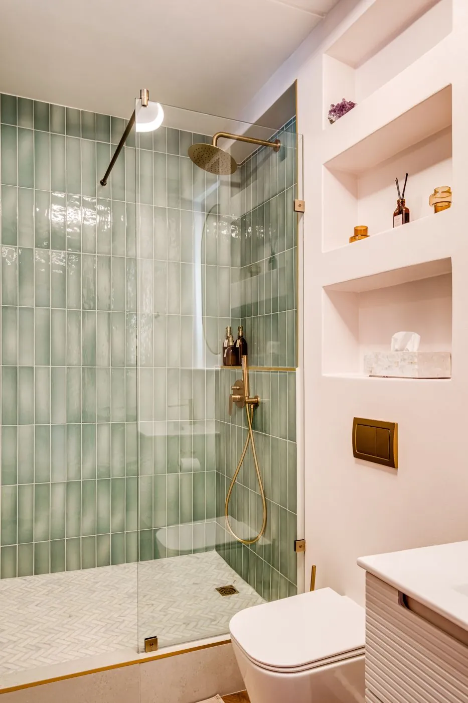 Bathroom with green tiles and a rain shower