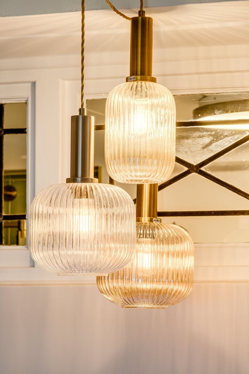 Ribbed glass pendant lamps over the dining table